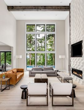 Luxury living room with view of tress and backyard, Ballard Luxury Homes