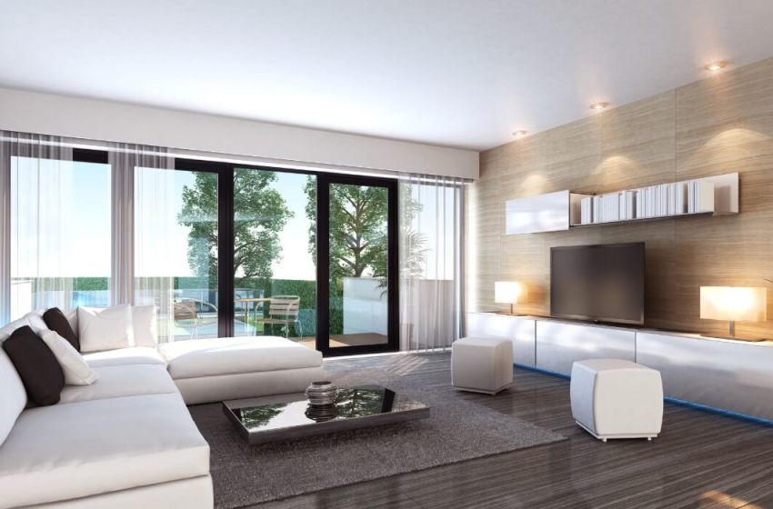 Luxury living with furnishings and sliding glass door, ocean, trees and backyard outside